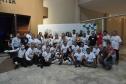 Encontro de Agentes de Crédito em Foz do Iguaçu - agentes de crédito e de desenvolvimento agrupados em duas fileiras, posam para foto em frente a um painel.