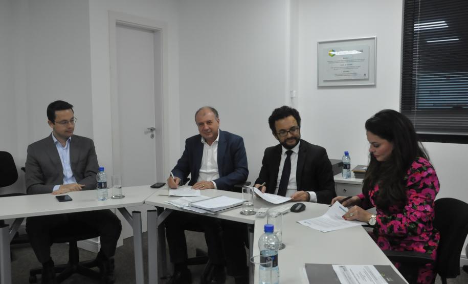 Heraldo Neves, Keli Guimarães e o secretário João Carlos Ortega assinam termo de compromisso entre a Fomento Paraná e o Cedes